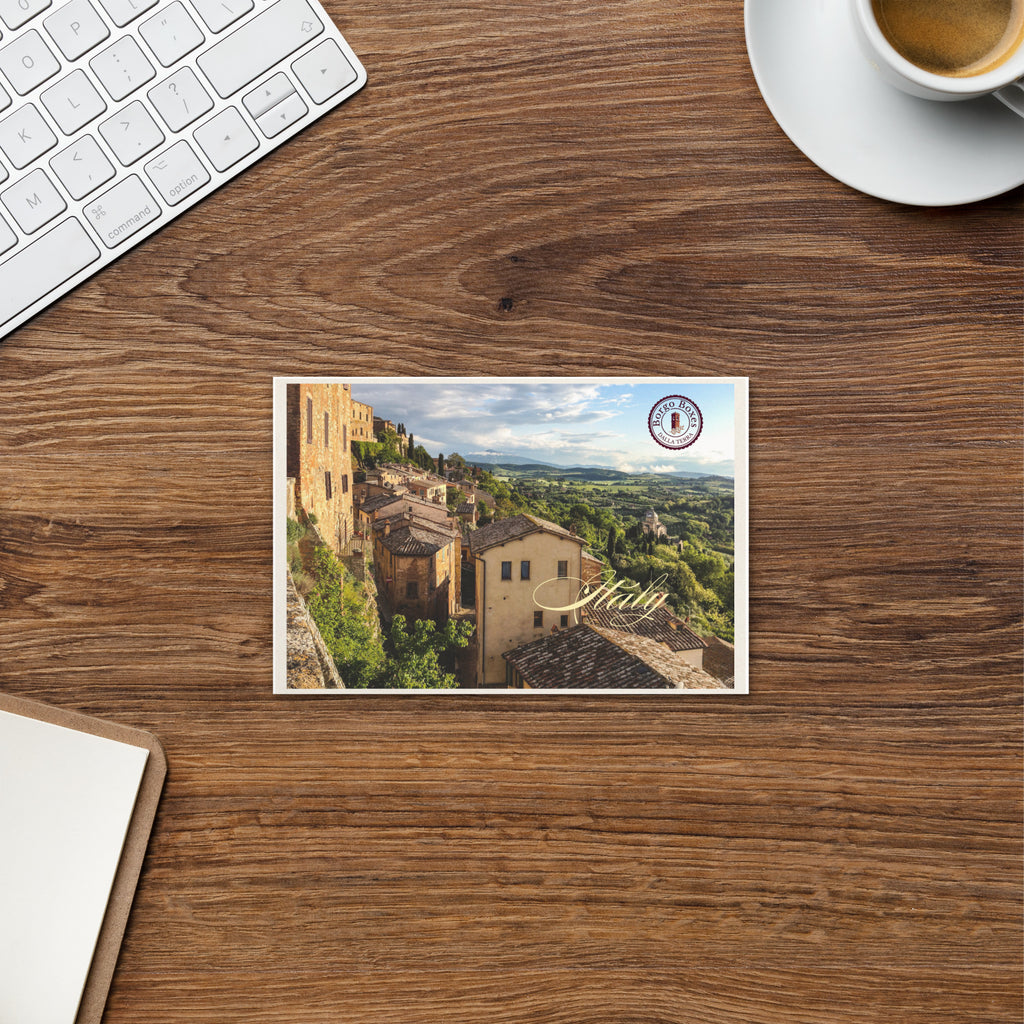 A postcard from Italy is sitting on a wooden desk and will be part of a handmade gift. 