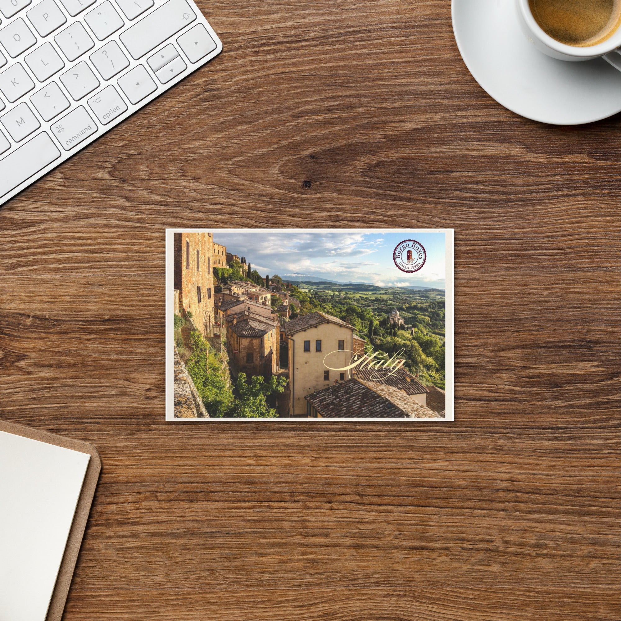 A postcard from Italy is sitting on a wooden desk and will be part of a handmade gift. 